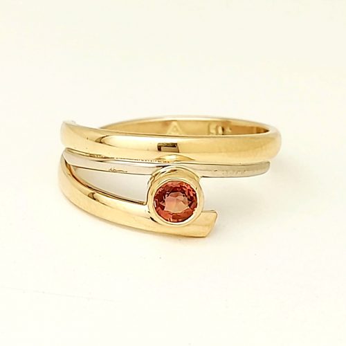 Gold and white gold ring with orange sapphire